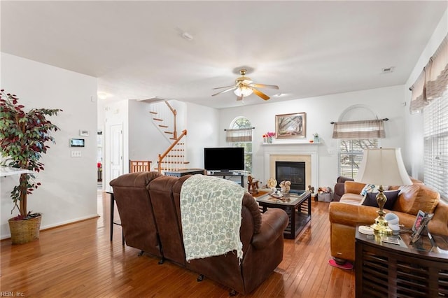 106 Elm Tree Ct, Suffolk, VA 23435 - living area with a glass covered fireplace, baseboards, stairs, ceiling fan, and wood-type flooring