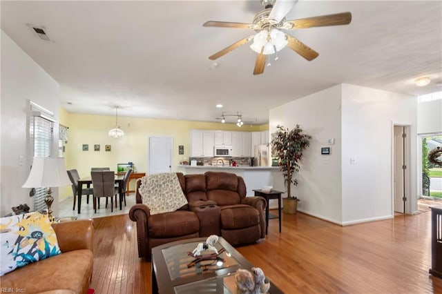 106 Elm Tree Ct, Suffolk, VA 23435 - living area with light wood-style flooring, baseboards, visible vents, and ceiling fan