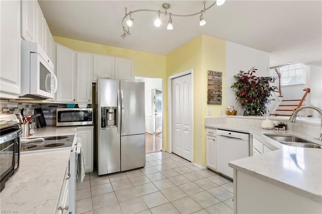 106 Elm Tree Ct, Suffolk, VA 23435 - kitchen featuring tasteful backsplash, a sink, appliances with stainless steel finishes, white cabinetry, and light tile patterned flooring