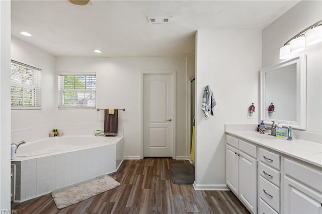 106 Elm Tree Ct, Suffolk, VA 23435 - bathroom with vanity, recessed lighting, visible vents, a garden tub, and wood finished floors