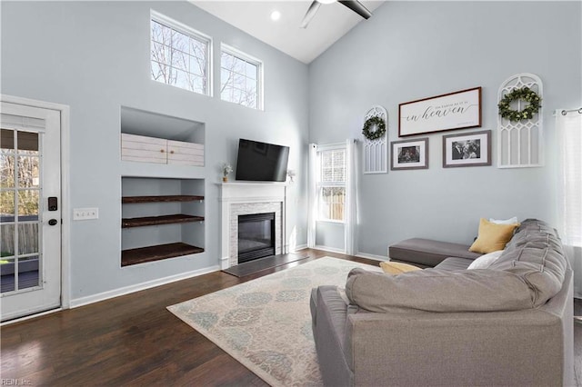 living area featuring high vaulted ceiling, ceiling fan, baseboards, and dark wood-style floors