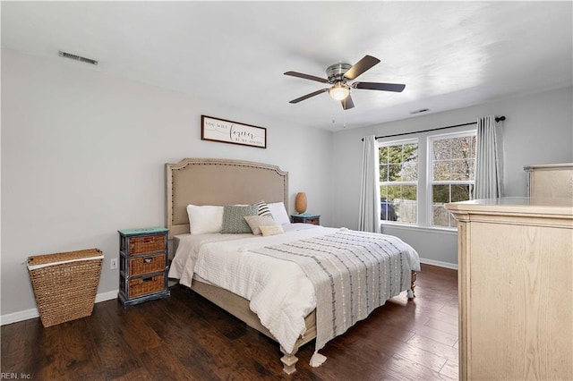 bedroom featuring ceiling fan, baseboards, dark wood-style flooring, and visible vents