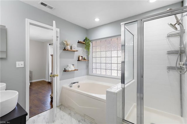 bathroom featuring a garden tub, visible vents, marble finish floor, and a shower stall