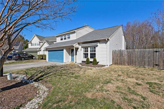 traditional-style house with a front lawn, concrete driveway, fence, an attached garage, and a shingled roof