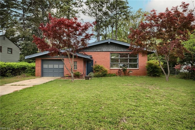 view of front of house with a garage, brick siding, a front yard, and concrete driveway