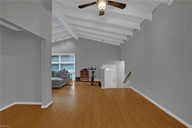 living area with wood finished floors, beam ceiling, baseboards, high vaulted ceiling, and ceiling fan