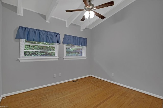 unfurnished room featuring lofted ceiling with beams, baseboards, a ceiling fan, and wood finished floors