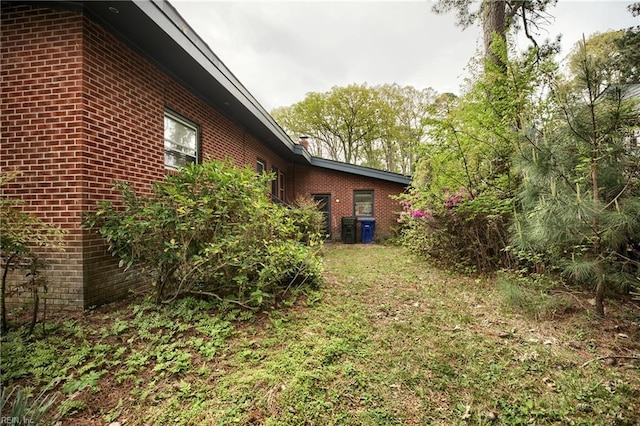 view of property exterior with brick siding
