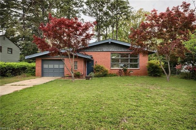 view of front of house featuring an attached garage, a front lawn, brick siding, and concrete driveway