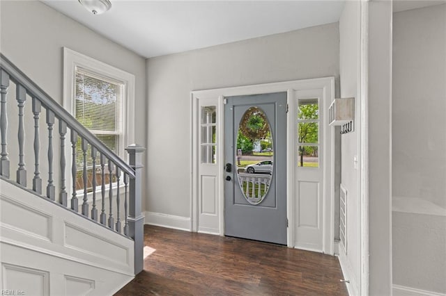 entrance foyer featuring wood finished floors, stairs, and baseboards