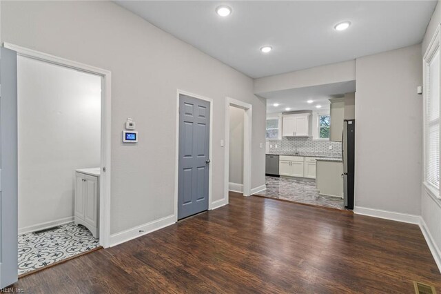interior space featuring recessed lighting, visible vents, backsplash, and wood finished floors