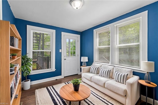 living area with wood finished floors and baseboards