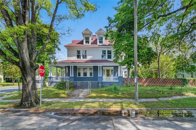 view of front of house with covered porch, a gate, and a fenced front yard