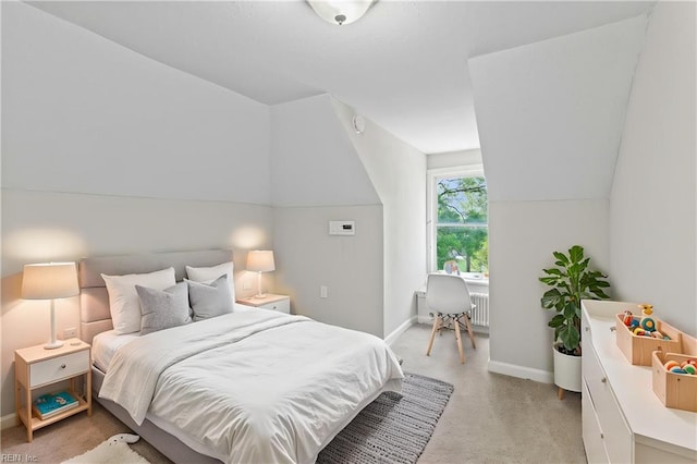 bedroom with baseboards, lofted ceiling, and light colored carpet