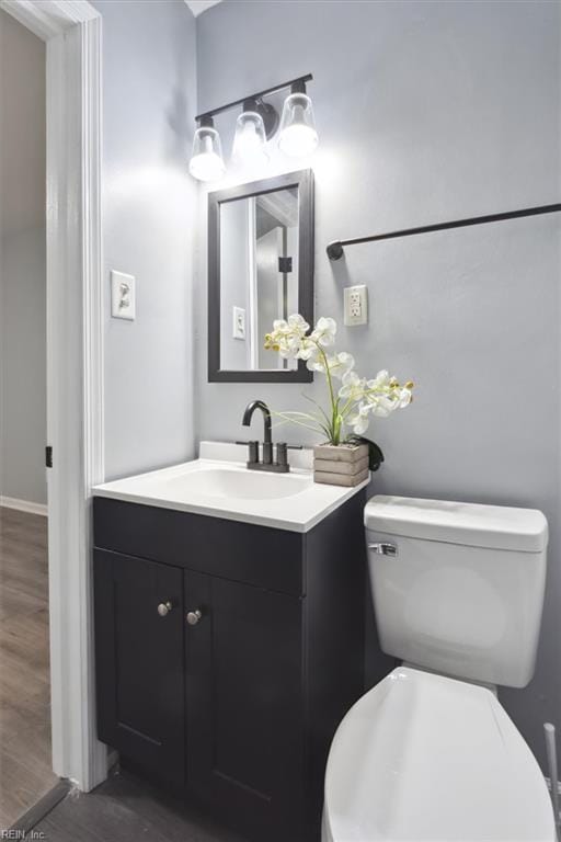 122 Kendall Dr, Newport News, VA 23601 - bathroom with toilet, vanity, wood finished floors, and baseboards