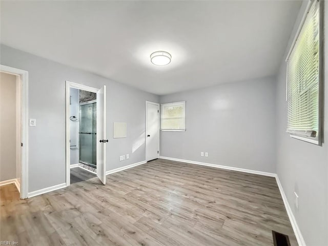 122 Kendall Dr, Newport News, VA 23601 - unfurnished bedroom featuring wood finished floors, baseboards, visible vents, and connected bathroom