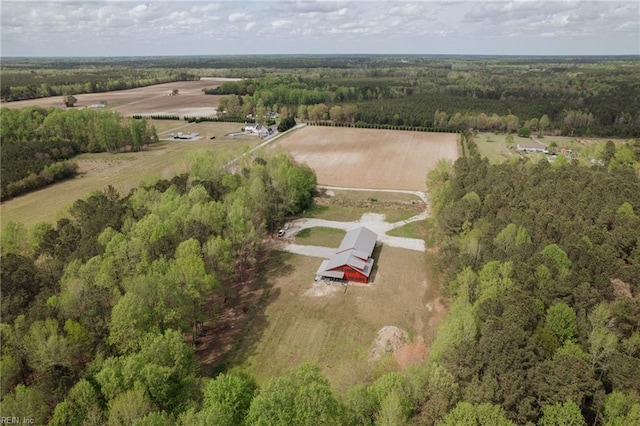drone / aerial view featuring a rural view and a forest view