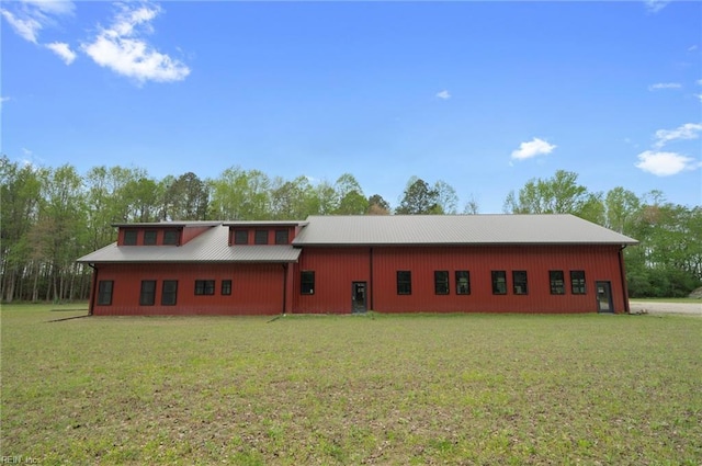 view of front facade featuring a front lawn and metal roof