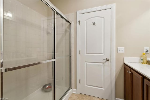 full bathroom with tile patterned flooring, vanity, and a stall shower