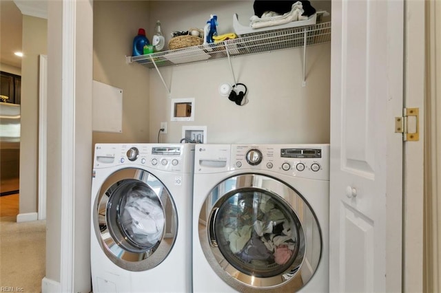clothes washing area with carpet, independent washer and dryer, and laundry area
