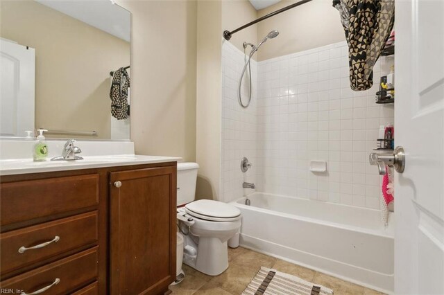 bathroom with tile patterned floors, toilet, vanity, and bathing tub / shower combination