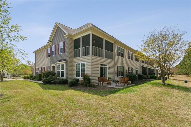 back of house featuring a patio and a yard