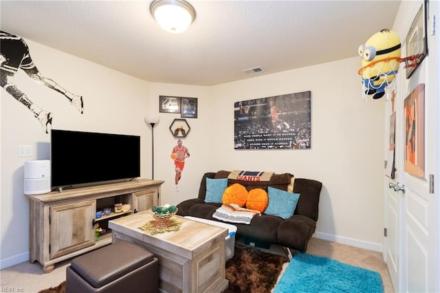 carpeted living area with baseboards and visible vents