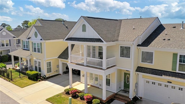 209 Cobblestone Reach Reach, Suffolk, VA 23435 - multi unit property featuring concrete driveway, a balcony, a garage, fence, and a shingled roof