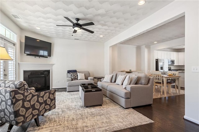 209 Cobblestone Reach Reach, Suffolk, VA 23435 - living area with baseboards, dark wood-style flooring, ceiling fan, recessed lighting, and a glass covered fireplace