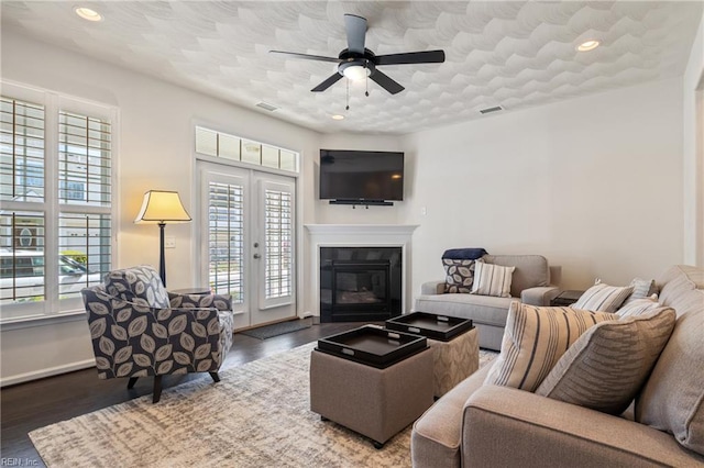 209 Cobblestone Reach Reach, Suffolk, VA 23435 - living area featuring wood finished floors, a glass covered fireplace, a ceiling fan, and visible vents