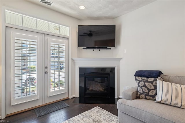 209 Cobblestone Reach Reach, Suffolk, VA 23435 - living area featuring a glass covered fireplace, plenty of natural light, visible vents, and dark wood-style flooring