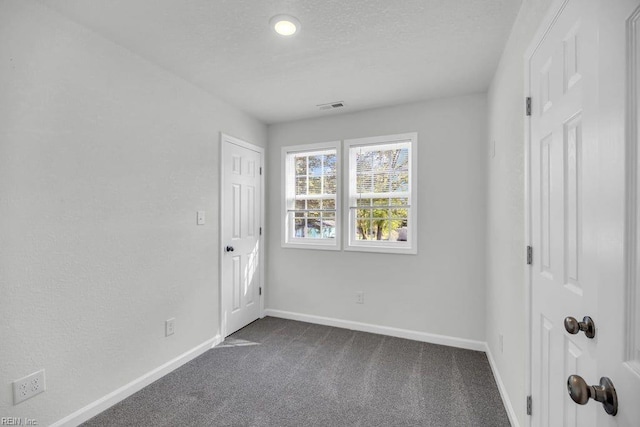 9289 Gates Rd, Suffolk, VA 23437 - unfurnished room featuring dark carpet, a textured ceiling, baseboards, and visible vents