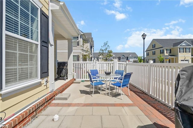 view of patio featuring outdoor dining area and a residential view