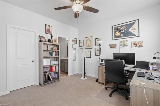office area featuring light colored carpet, baseboards, and a ceiling fan