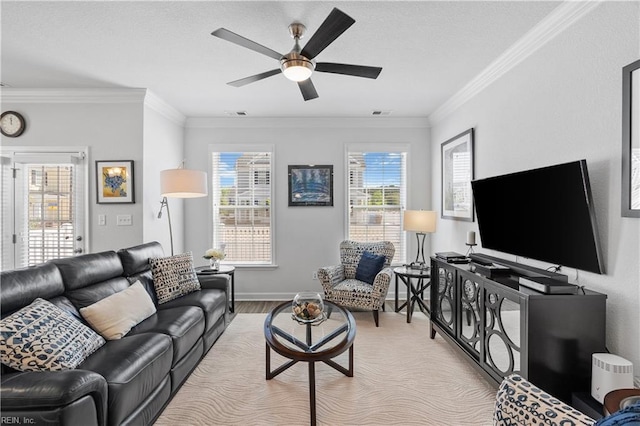 living area with crown molding, light wood-style floors, a ceiling fan, and baseboards