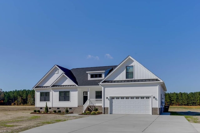 modern farmhouse style home featuring a standing seam roof, metal roof, board and batten siding, and concrete driveway