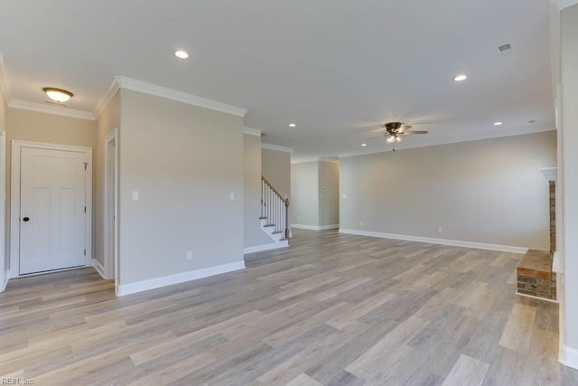 unfurnished living room featuring stairway, light wood-style floors, a ceiling fan, and ornamental molding