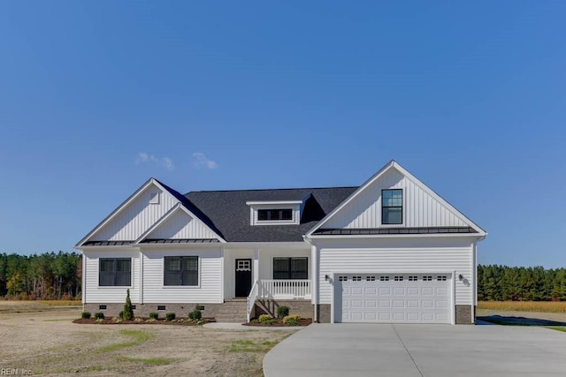 modern inspired farmhouse with board and batten siding, a standing seam roof, crawl space, metal roof, and concrete driveway
