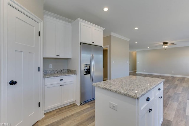 kitchen featuring a ceiling fan, a kitchen island, white cabinets, stainless steel refrigerator with ice dispenser, and light wood-style floors