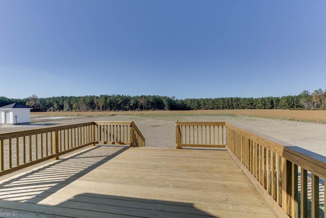 wooden terrace with a wooded view