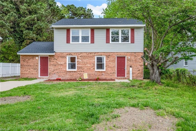 105 Ireland St, Hampton, VA 23663 - traditional home featuring brick siding, a front lawn, and fence