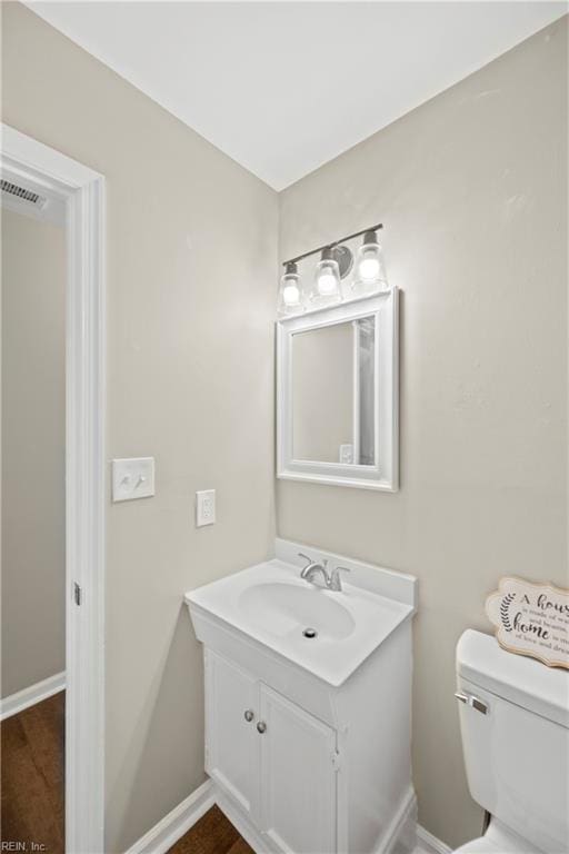 105 Ireland St, Hampton, VA 23663 - bathroom featuring toilet, vanity, baseboards, and visible vents