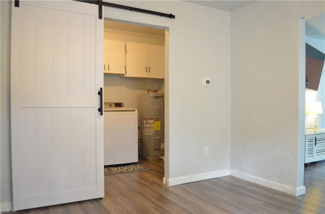 laundry area featuring water heater, washer / dryer, baseboards, and wood finished floors