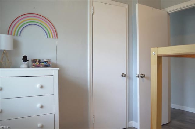 interior space with baseboards and wood finished floors