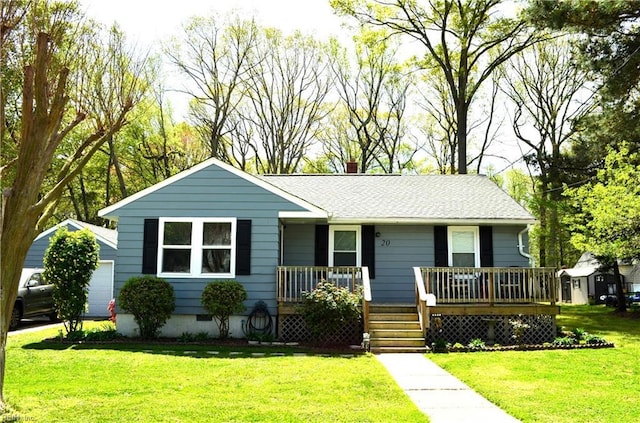 ranch-style house with an outbuilding, a front lawn, covered porch, and a chimney