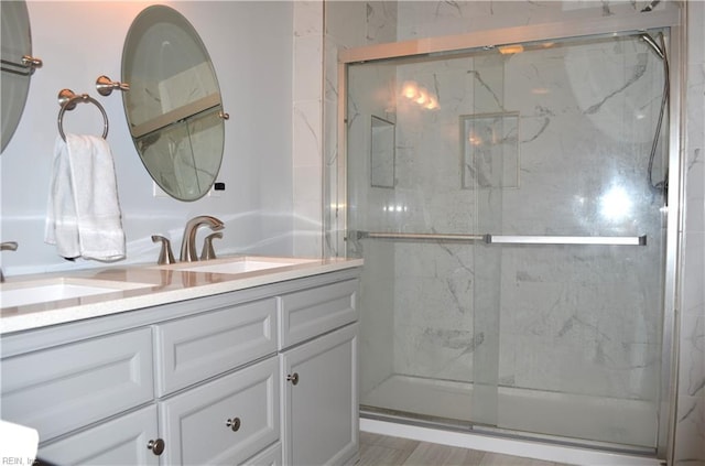 full bathroom with vanity and a marble finish shower