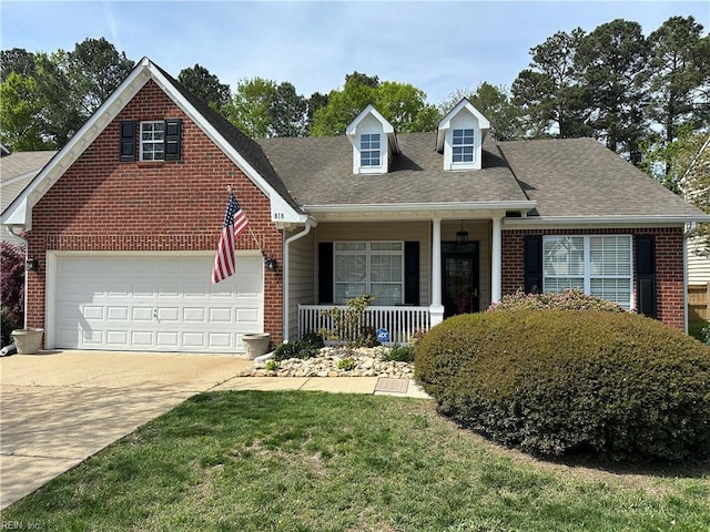 view of front facade with concrete driveway, a front yard, brick siding, a porch, and a garage