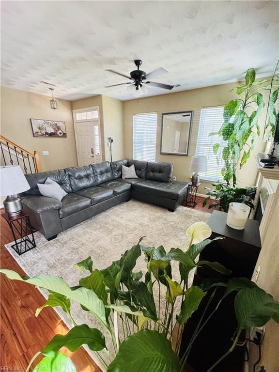 living room featuring ceiling fan and wood finished floors