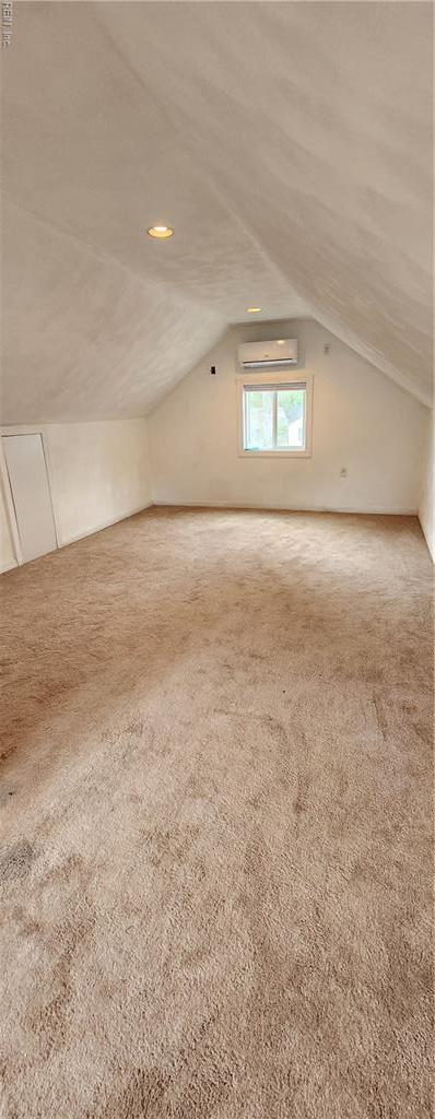 bonus room with recessed lighting, an AC wall unit, vaulted ceiling, and carpet floors