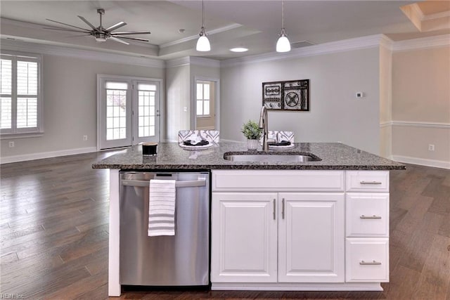 kitchen featuring a sink, dark stone counters, open floor plan, dishwasher, and ornamental molding